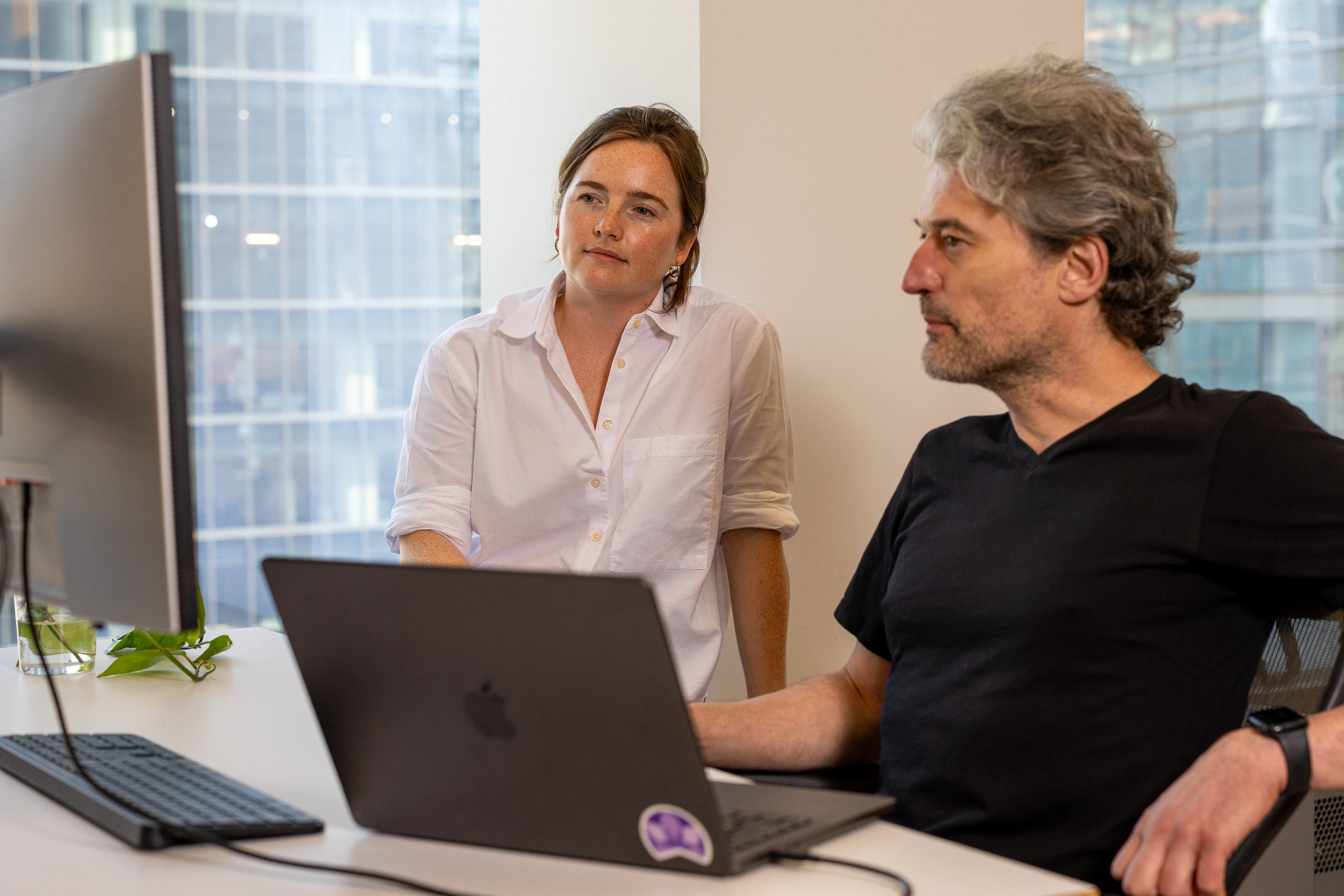 A photograph of two Betterment employees at a desk.